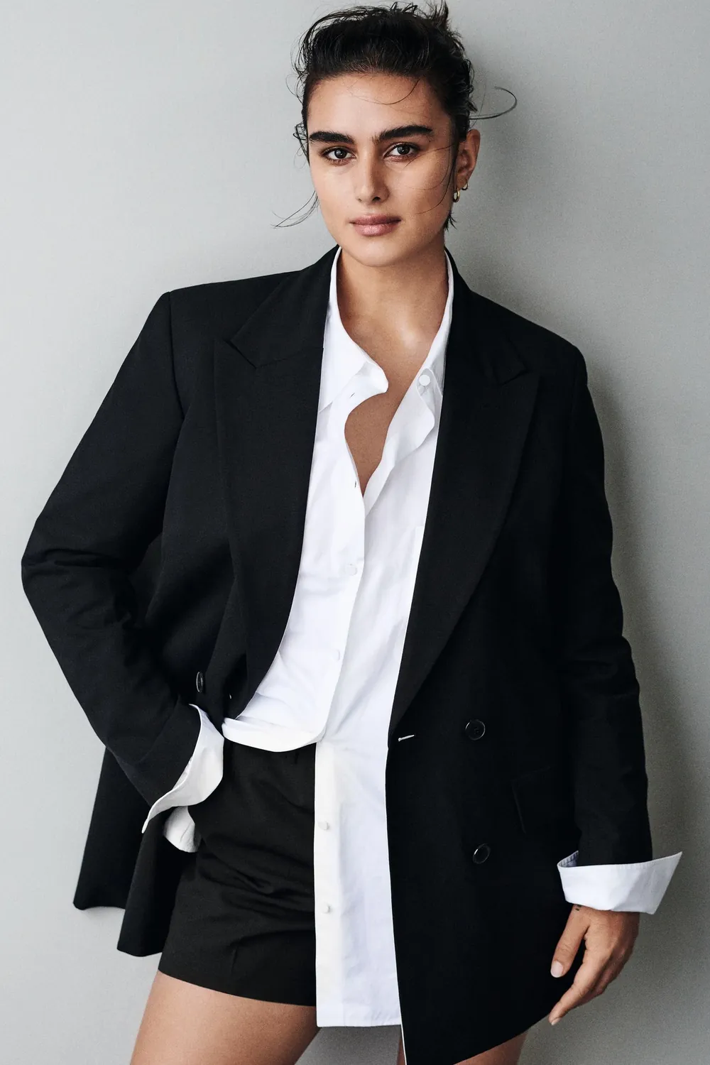 Jill Kortleve wearing a black blazer, white shirt and tailored black shorts.