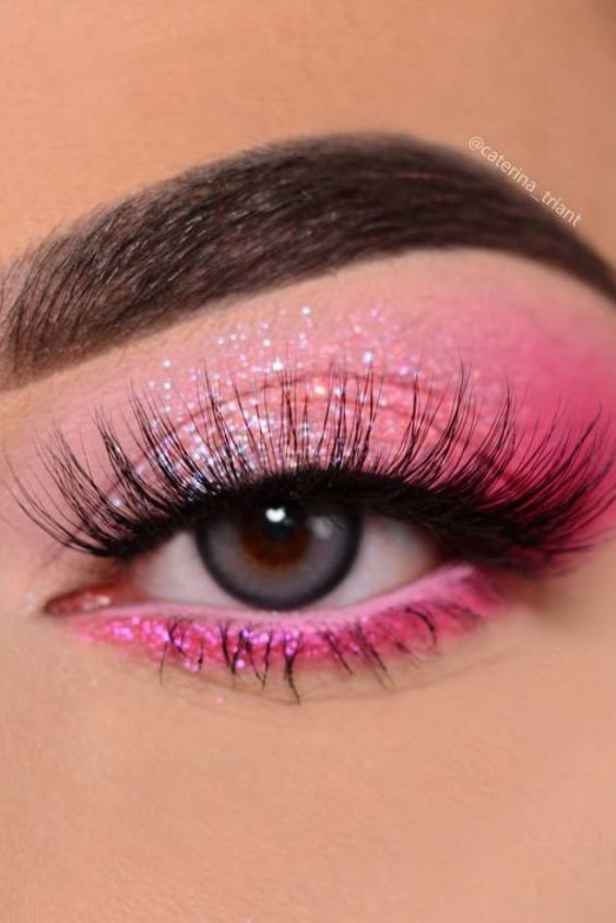 Close-up of pink glitter eyeshadow with long lashes