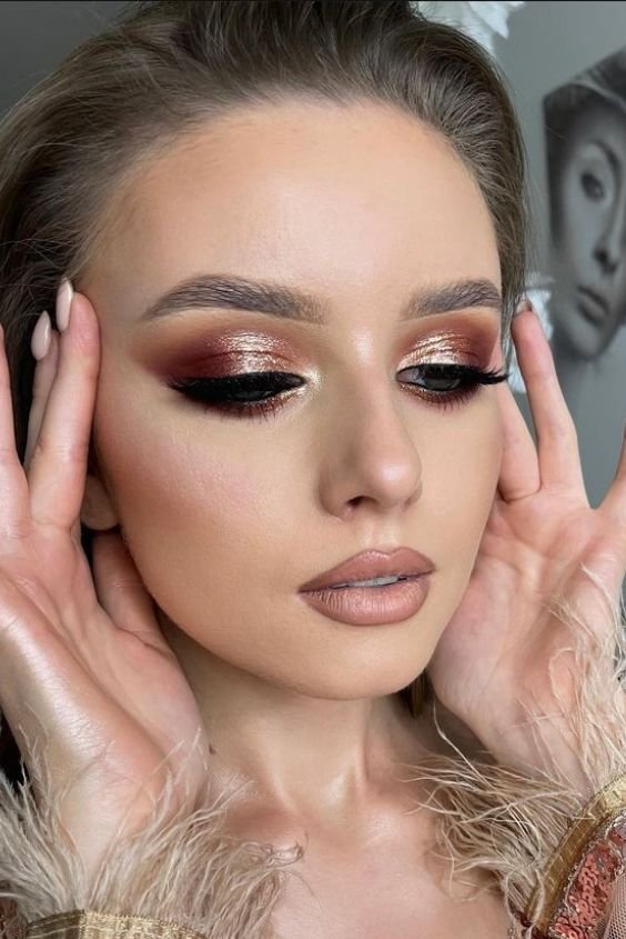 Woman with rose gold eyeshadow and a nude lip