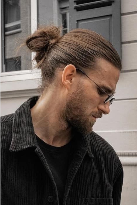 Slicked-Back Top Knot and Groomed Beard