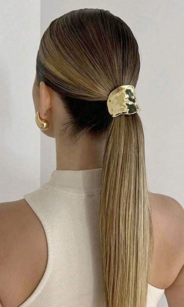 sleek low ponytail with gold hair cuffs