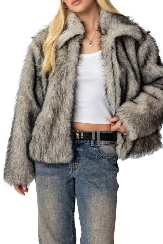 Woman in a grey cropped faux fur jacket with jeans and a white tank