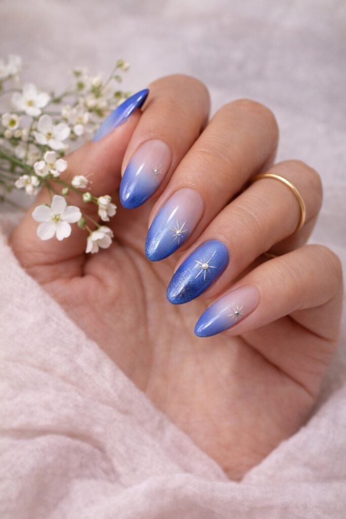 Almond nails with a blue aura effect