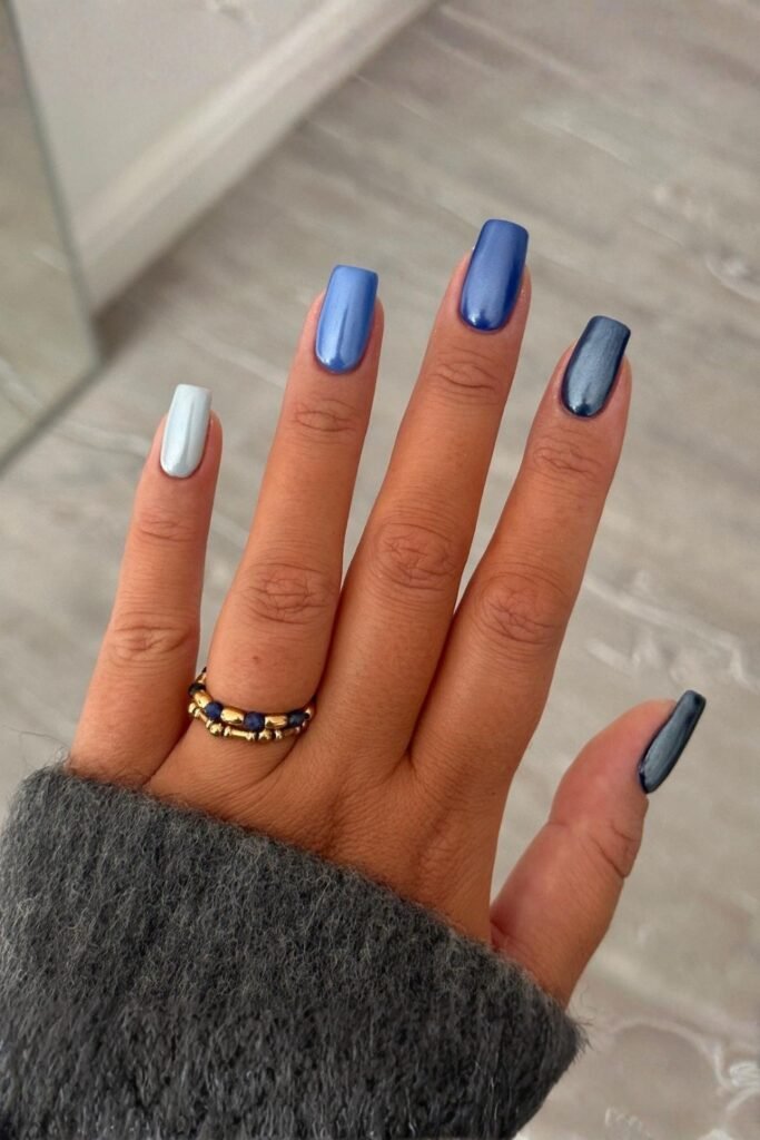 Almond nails with a shimmery blue gradient