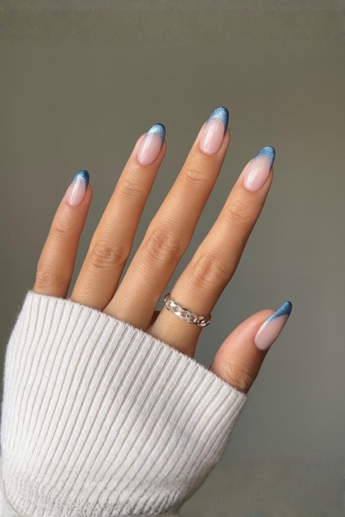 Almond nails with glittery blue French tips