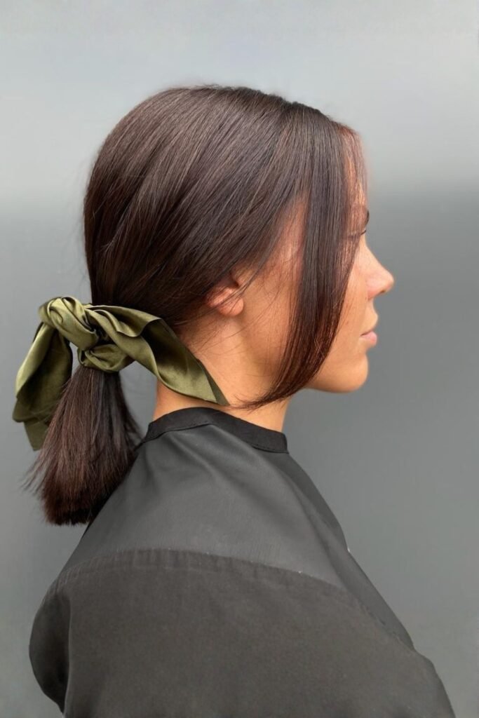 Side view of a low ponytail with face-framing strands