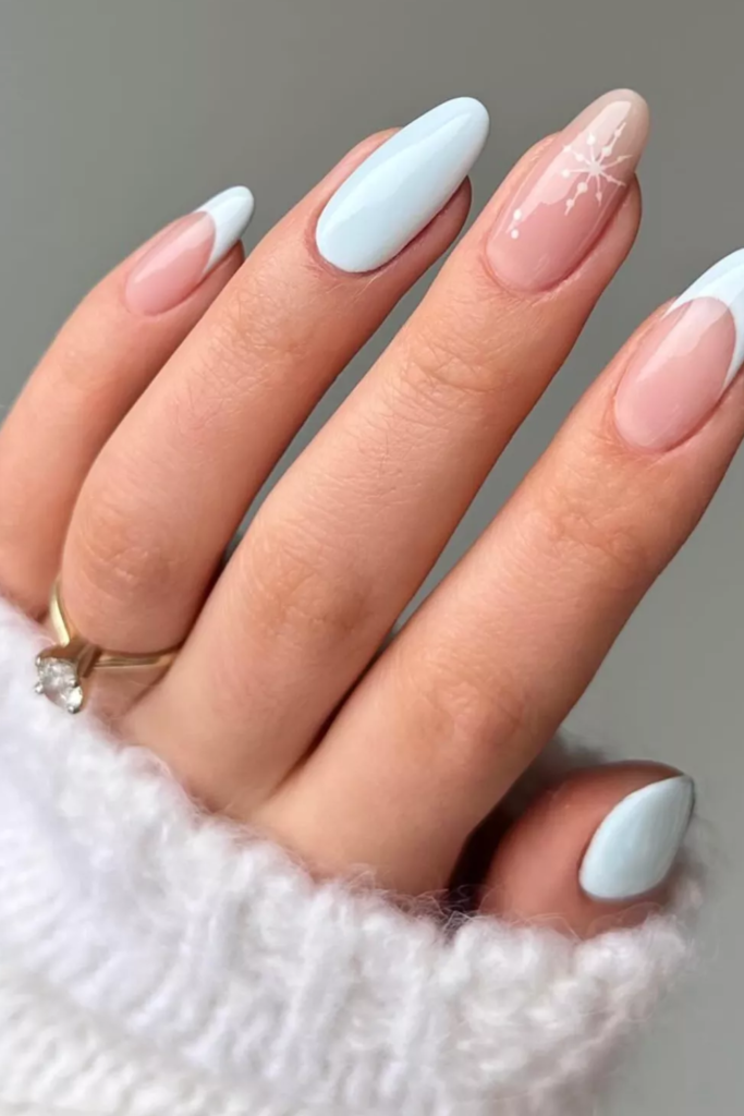 Almond nails in sheer nude and pale blue with minimal detail