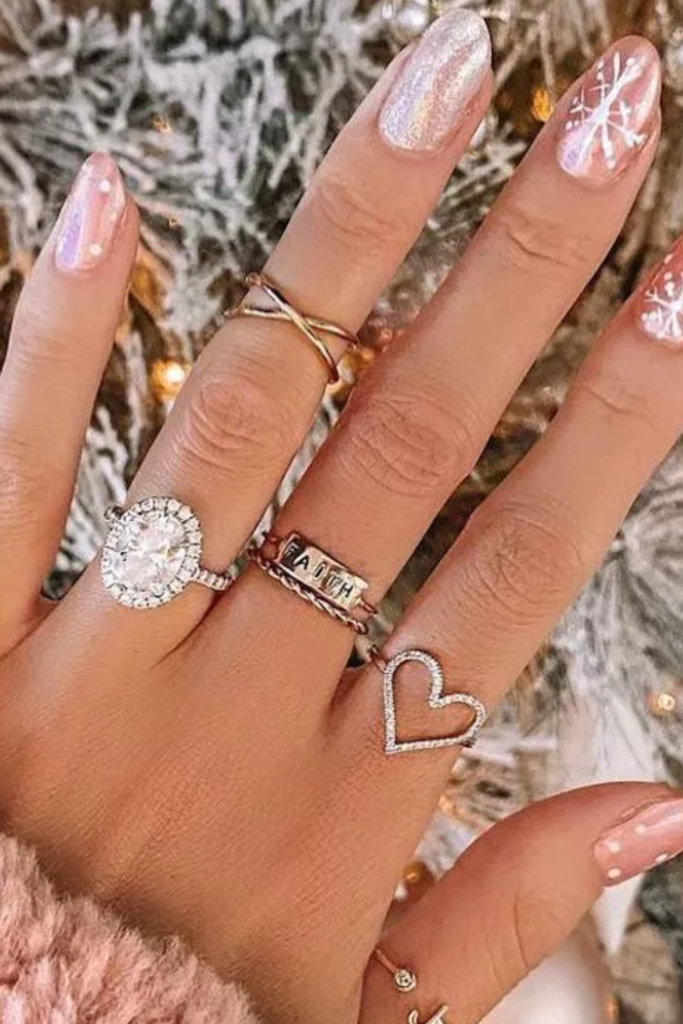 Sheer pink nails with rose gold glitter and fine snowflakes