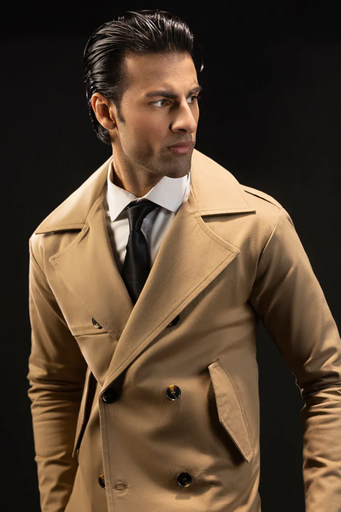 Man in a camel double-breasted cropped trench coat with a shirt and tie