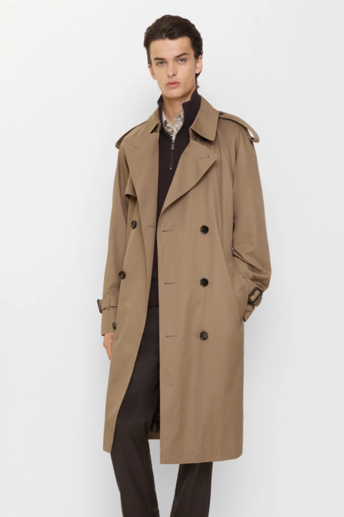 Man in a camel gabardine trench coat with dark trousers