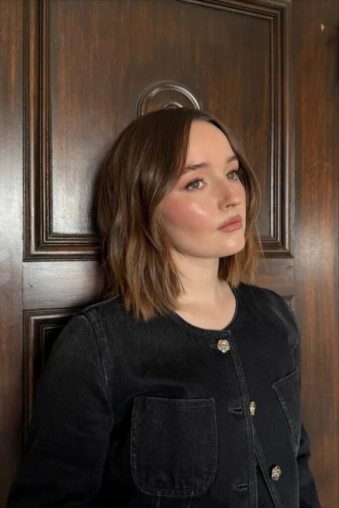 Brunette collarbone-length lob with a center part