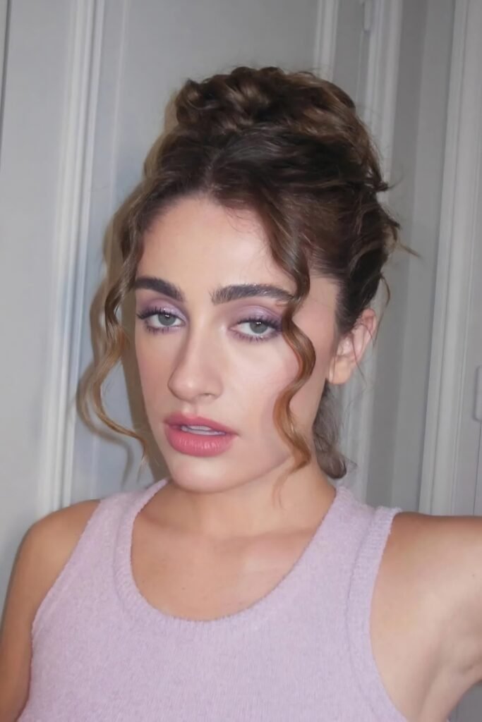 Curls piled on top of the head with loose tendrils