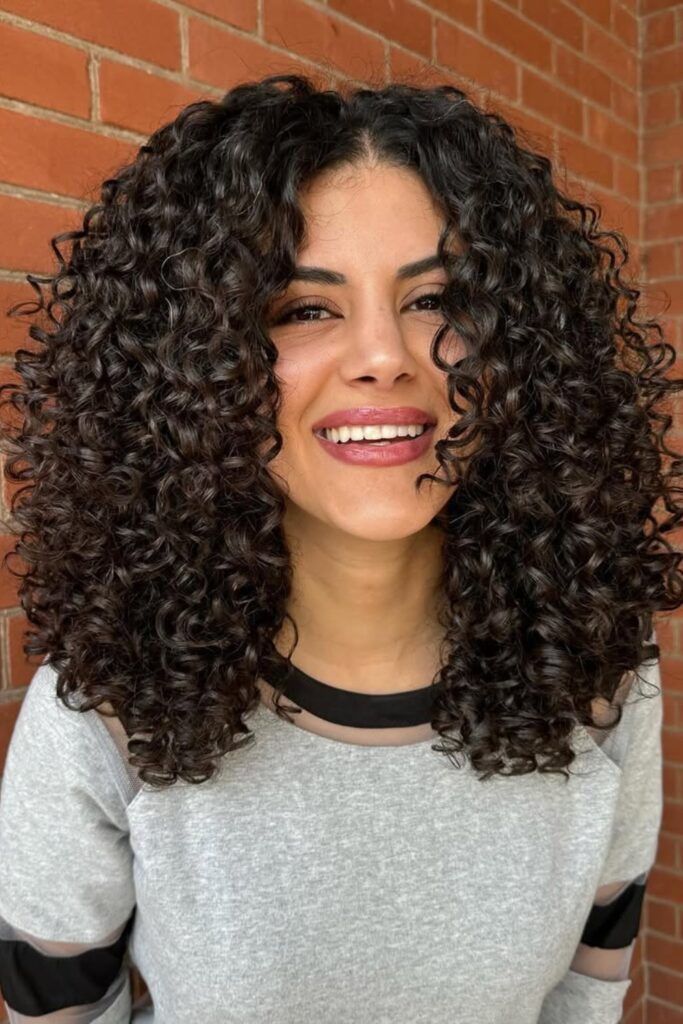 Shoulder-Length Defined Curls with Center Part