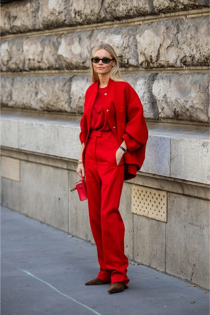 Woman in an all-red blazer and trousers