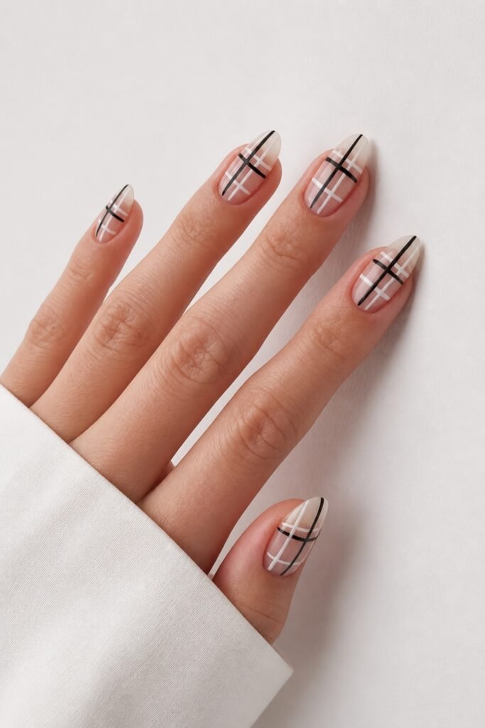 Long nude almond nails with thin black crossed lines