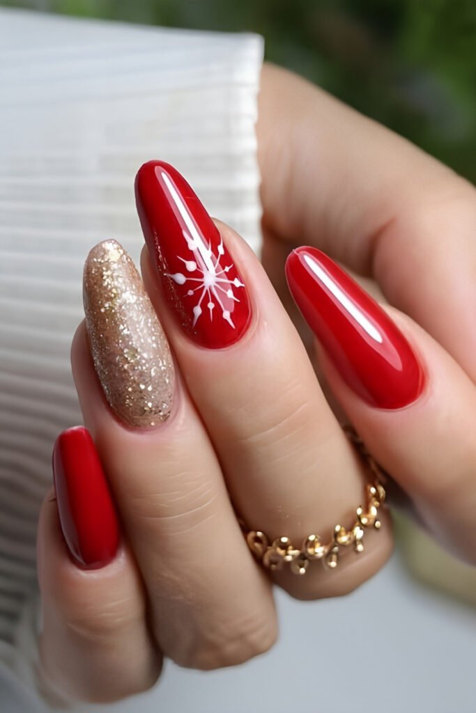 Red almond nails with a gold glitter accent nail