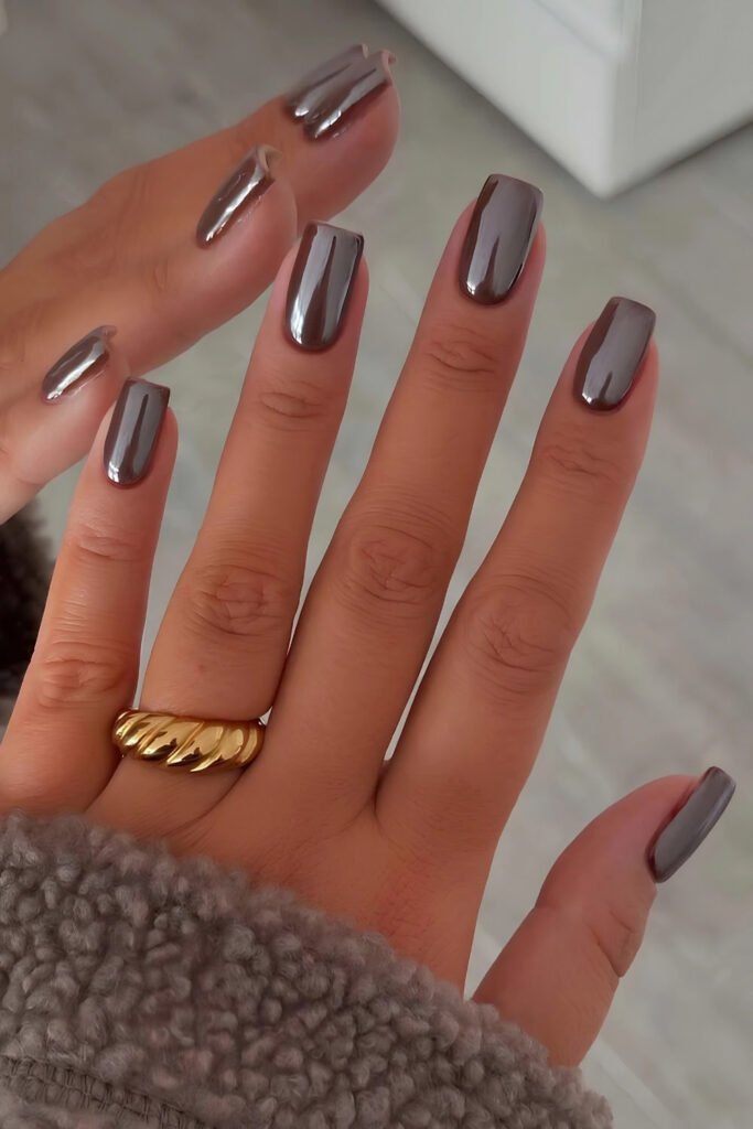 Mauve-burgundy chrome nails with a gold ring