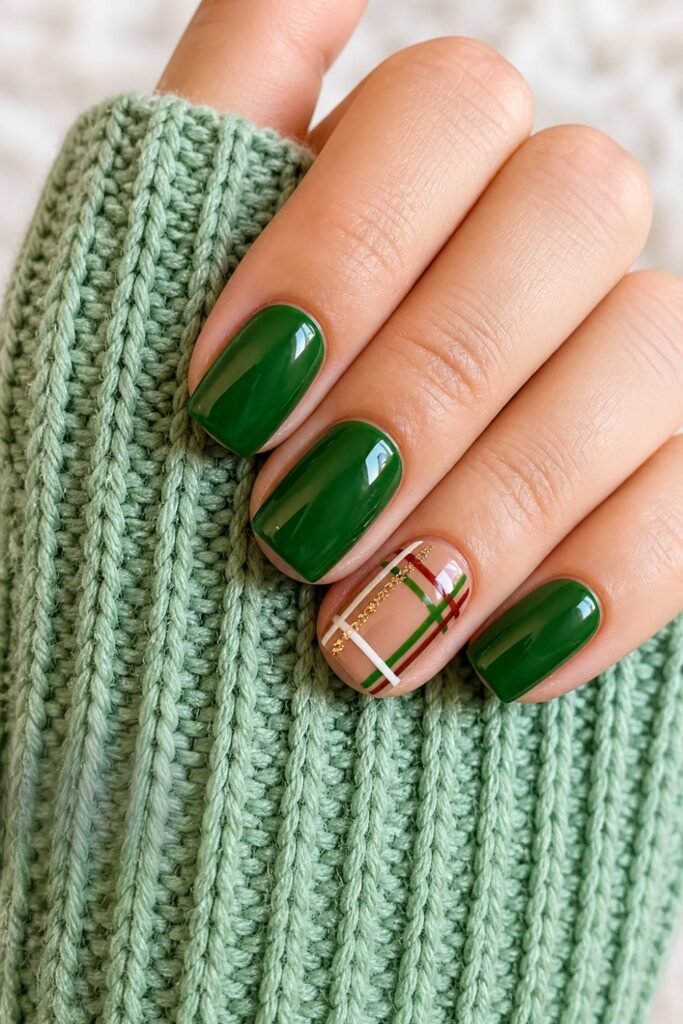 Forest green nails with one plaid accent nail and a green knit sleeve