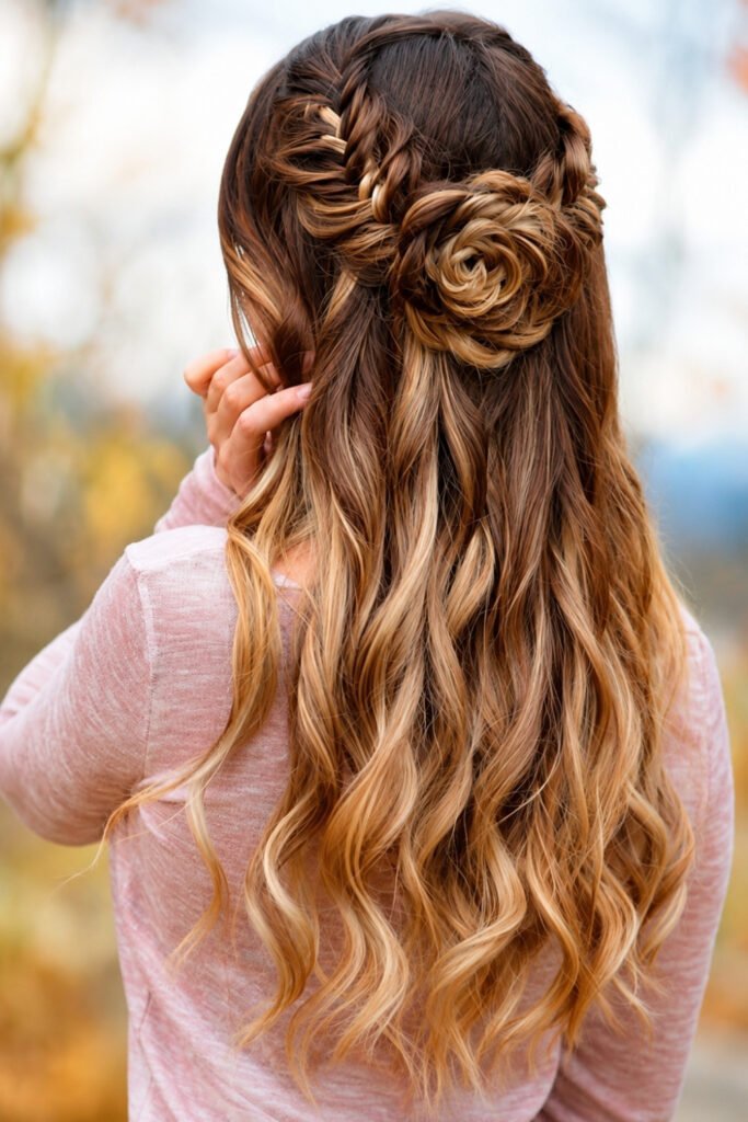 Back view of a half-up fishtail braid above loose curls