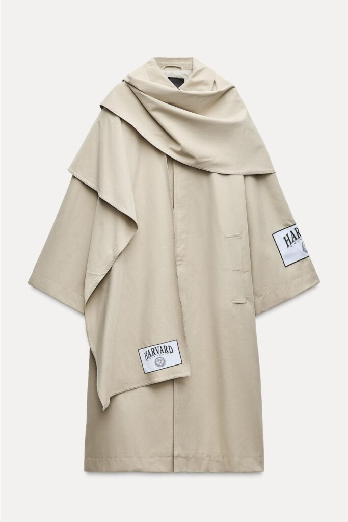 Cream cape-style trench coat shown on a plain background