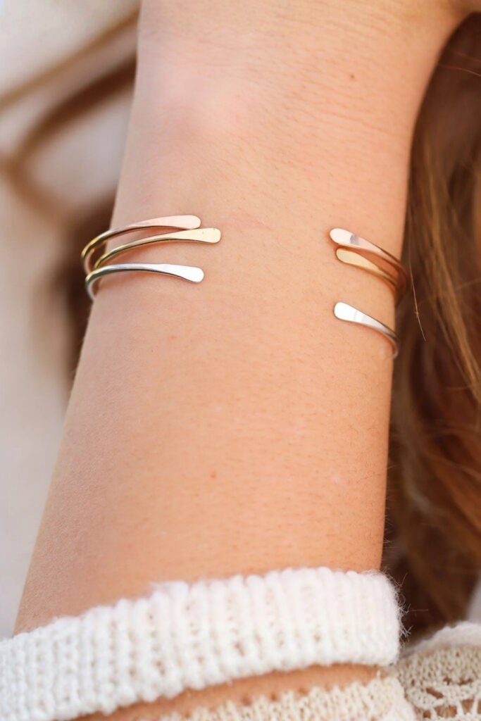 Gold layered thin cuffs bracelet on the wrist