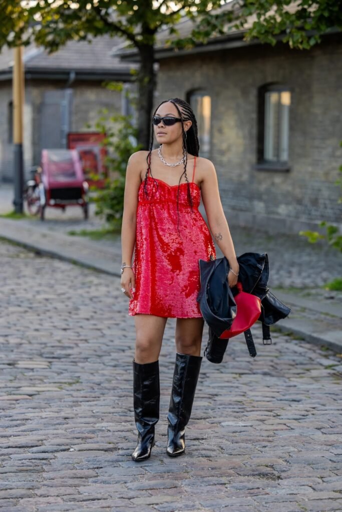 Woman in a red mini dress with black knee-high boots