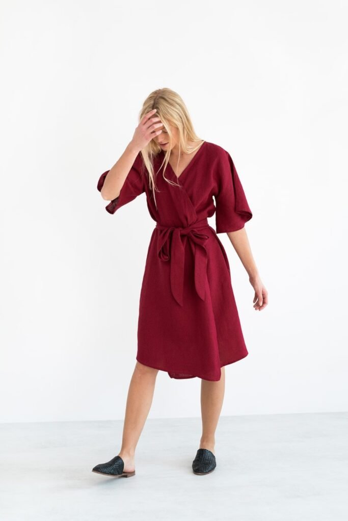 Woman in a dark cherry linen wrap dress