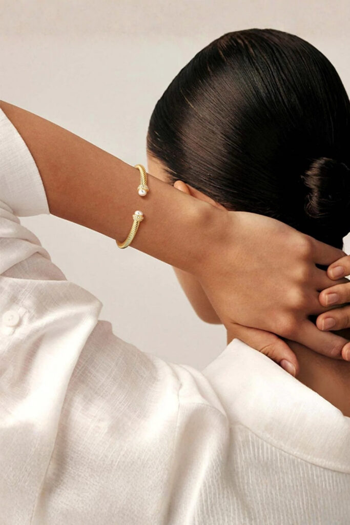 Gold open-ended minimalist cuff bracelet on the wrist
