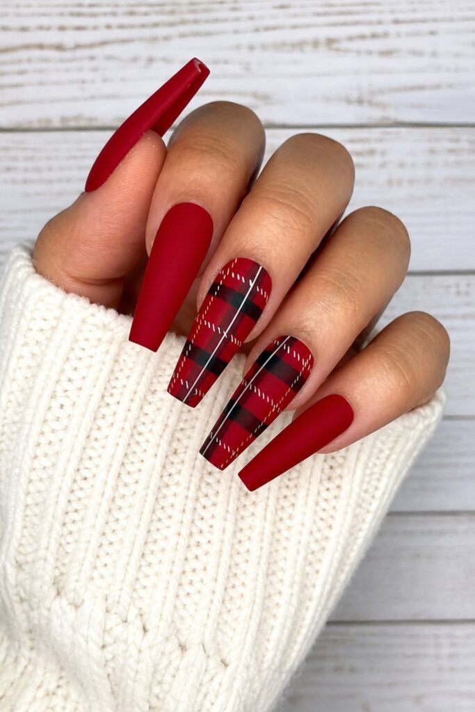 Long red tartan coffin nails against a white sweater