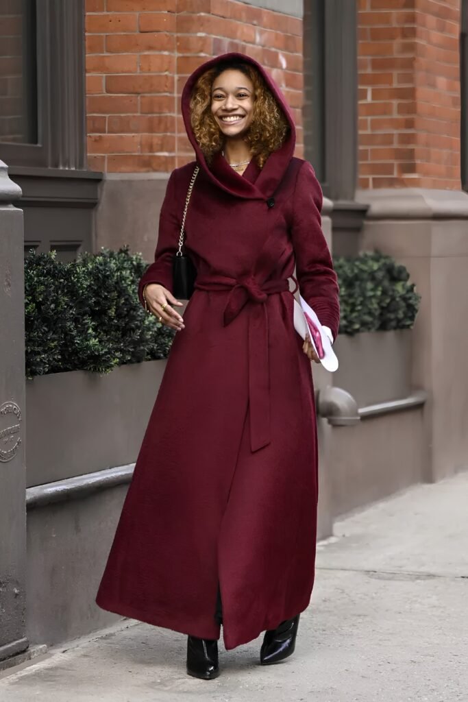 Woman in a hooded burgundy coat dress