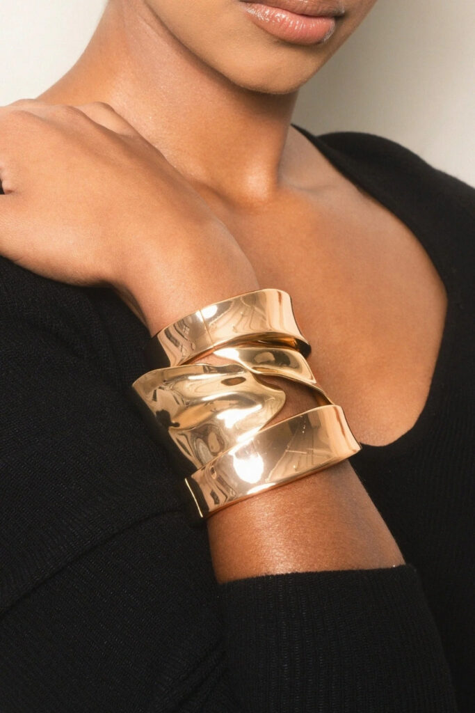 Gold sculptural layered set bracelet on the wrist