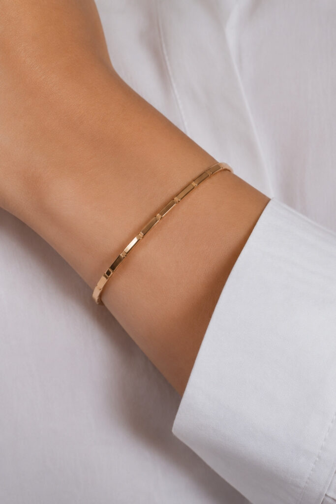 Gold sleek polished cuff bracelet on the wrist