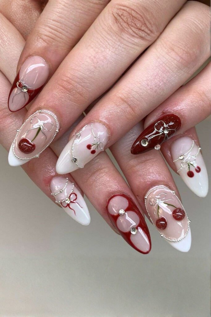 Milky white almond nails decorated with small 3D cherries