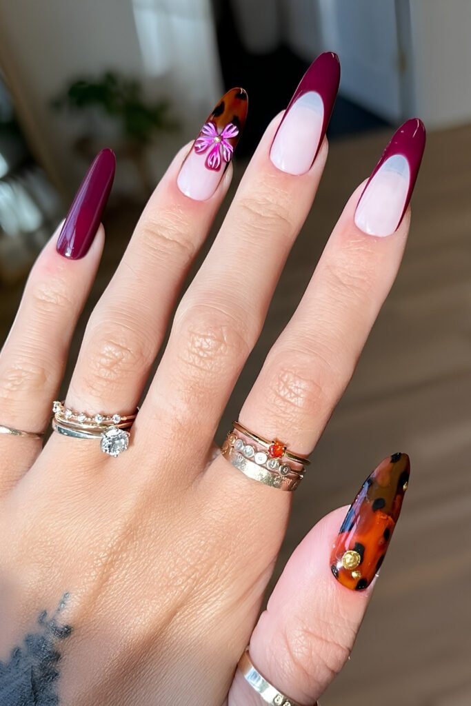 Almond nails mixing cherry mocha French tips with a tortoiseshell accent nail