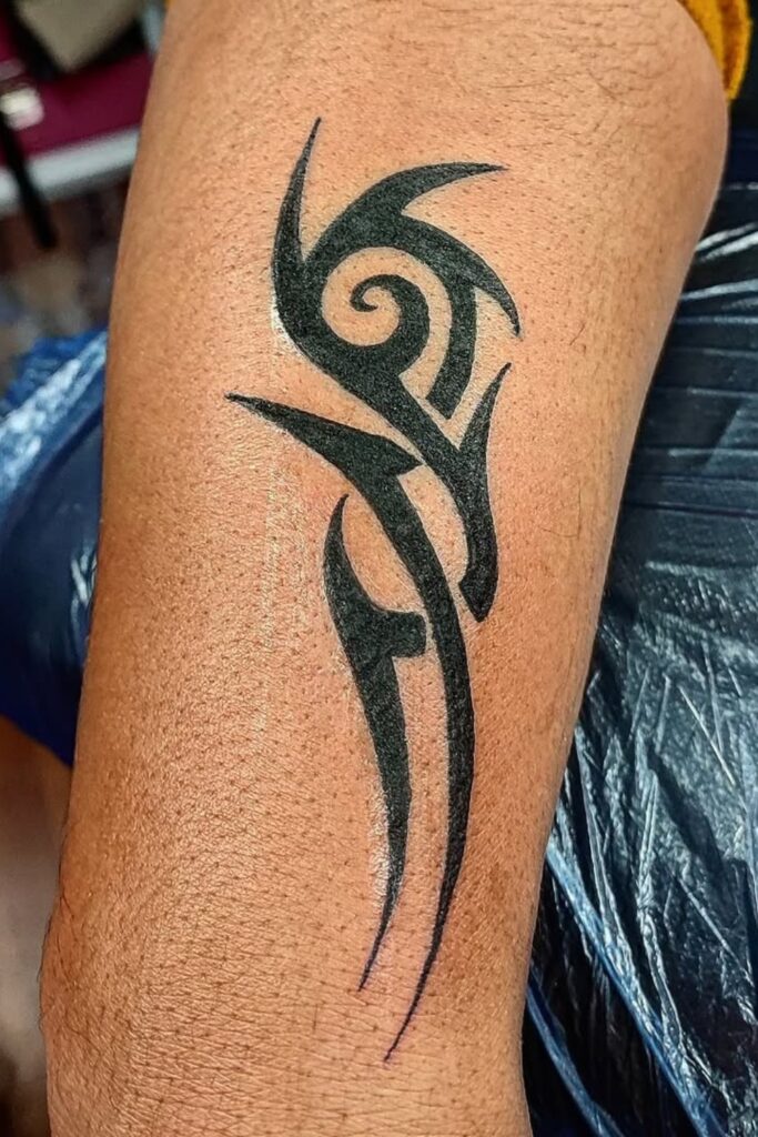Minimal tribal motif tattoo on a man