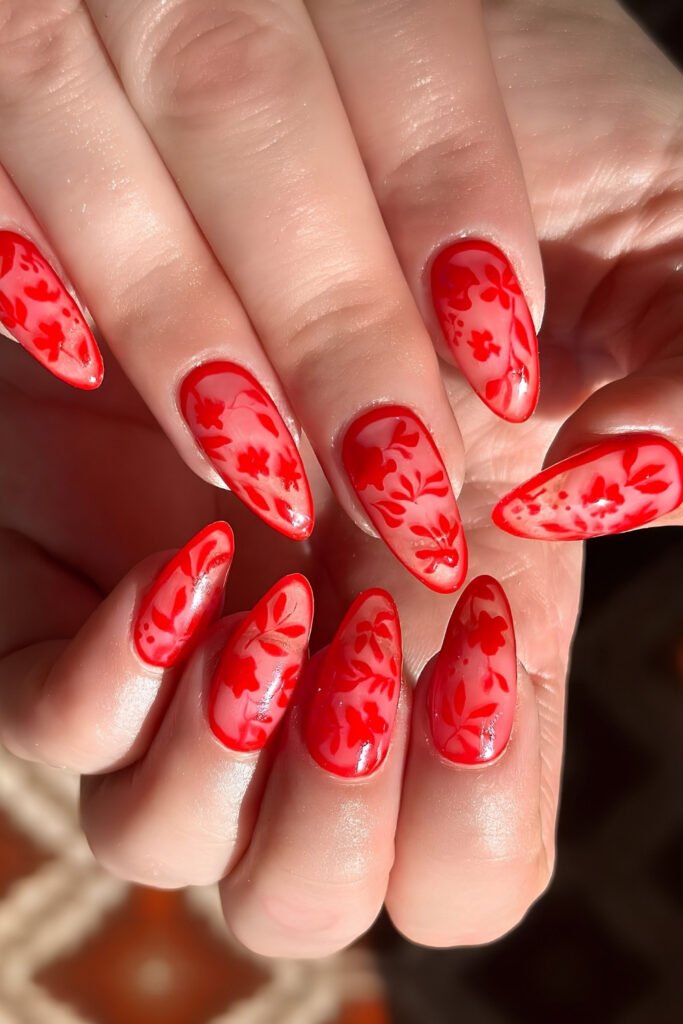 Long red nails with a darker red tonal pattern