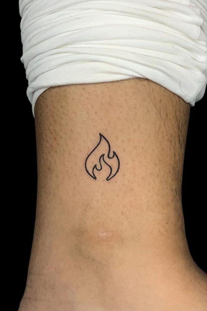 Small flame tattoo on a man