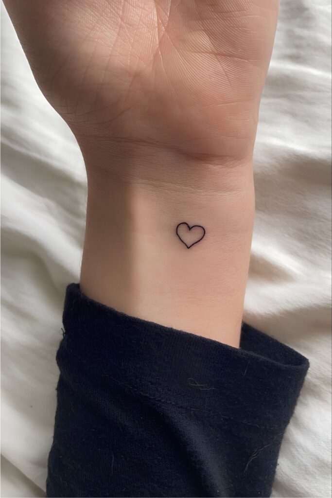 Tiny heart tattoo on a man