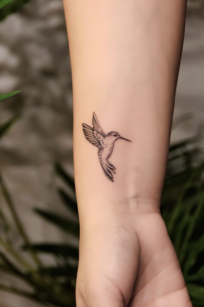 Tiny hummingbird tattoo on a man