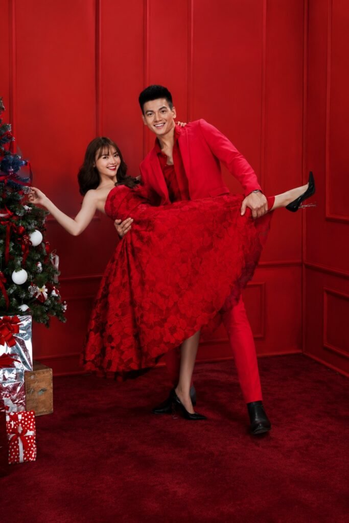 Couple dressed all in red against a red backdrop