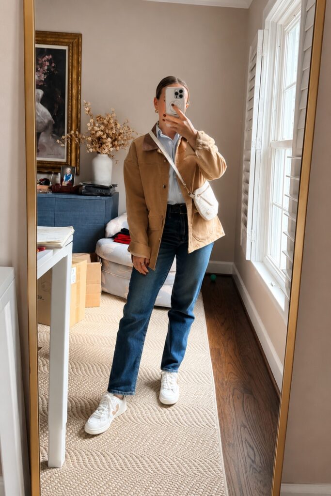 Barn jacket with a white tee, dark jeans and white sneakers
