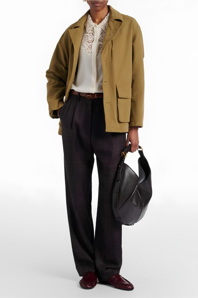 Barn jacket over a silk blouse with tailored trousers and loafers