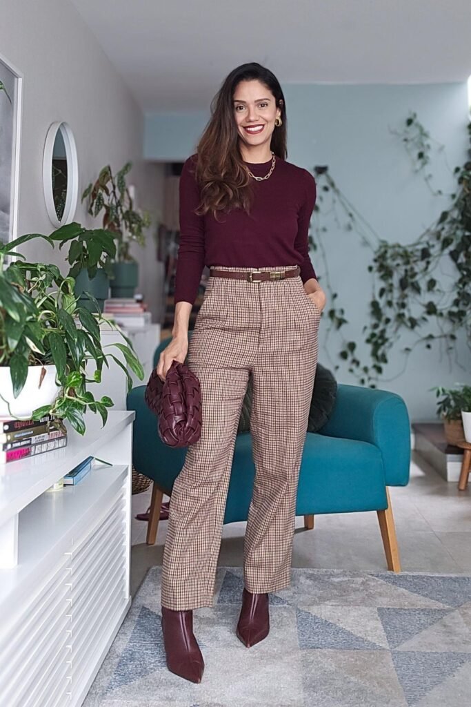 Woman in a burgundy turtleneck with plaid wide-leg trousers