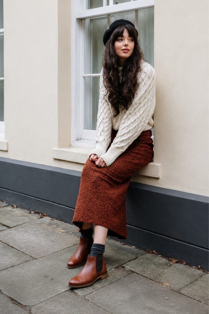 Chelsea boots with a midi skirt and fitted knit