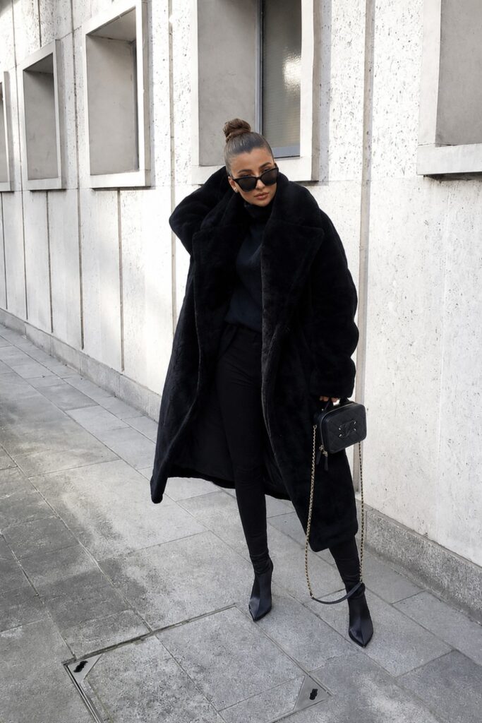 Faux fur coat over an all-black outfit