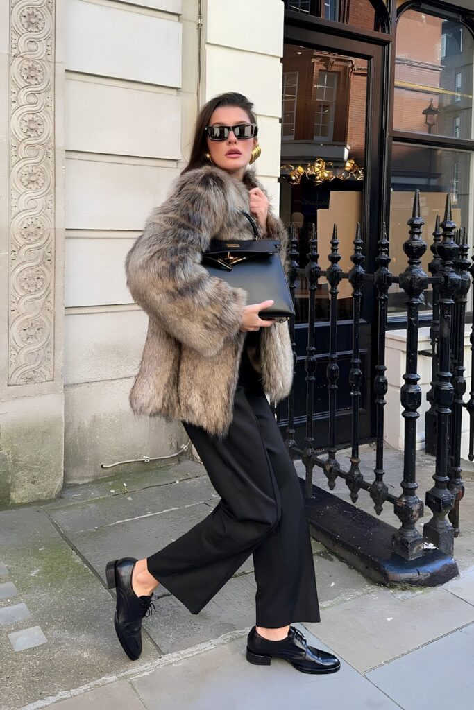Faux fur coat with tailored trousers and loafers