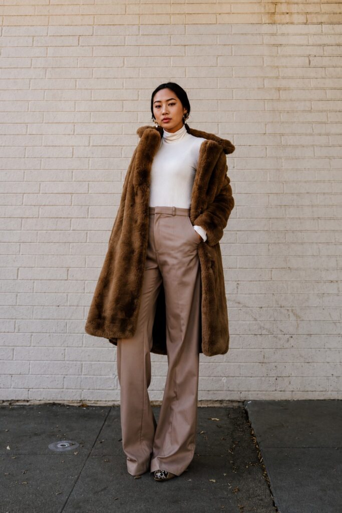 Faux fur coat with wide-leg trousers and heels
