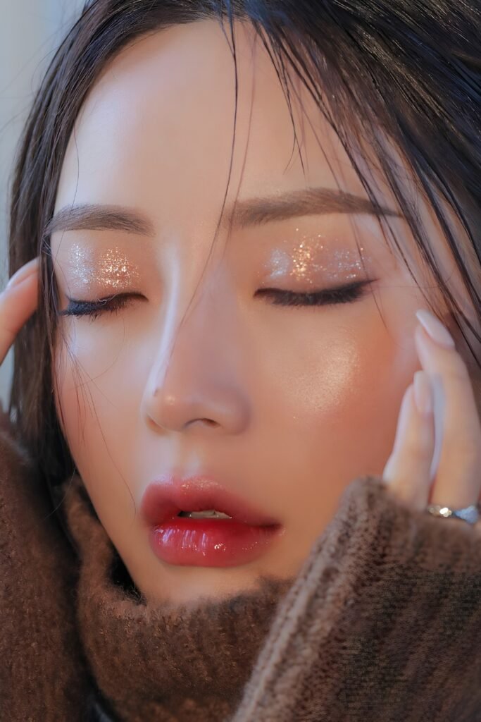 Woman with closed eyes showing rose gold shimmer eyeshadow