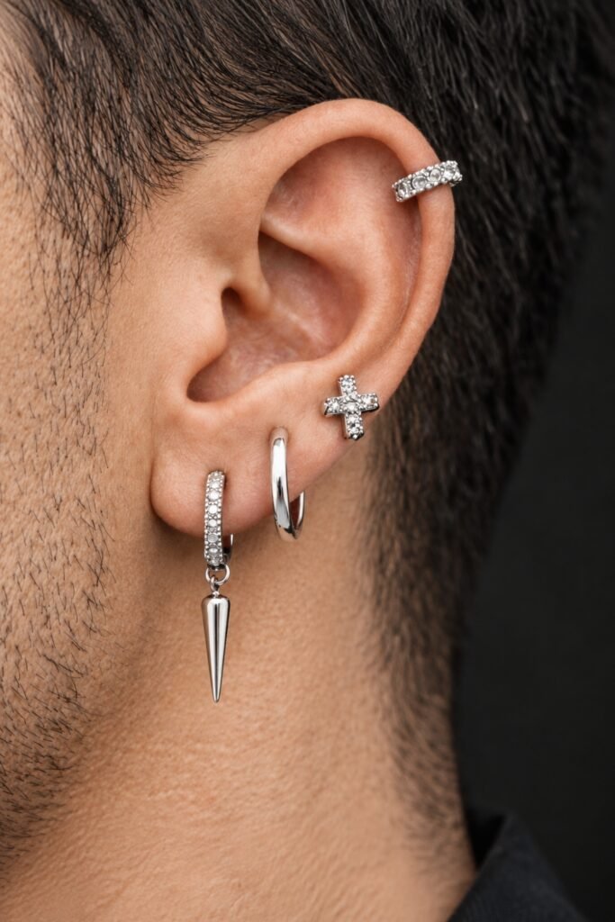 Asymmetric curated ear with several piercings
