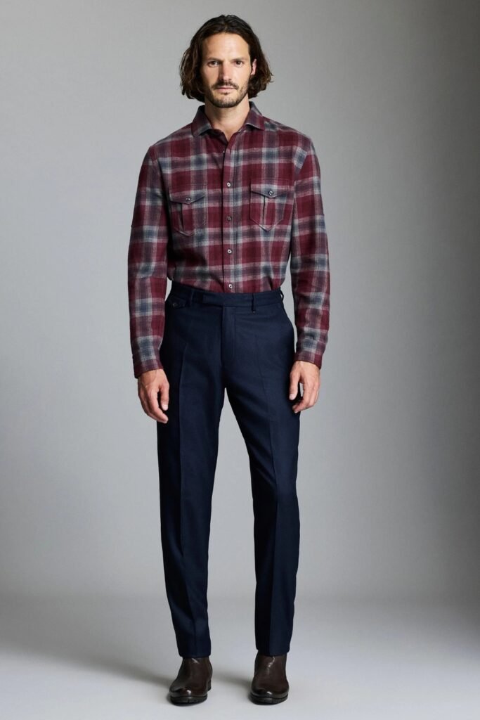 Man in a burgundy plaid flannel with navy trousers